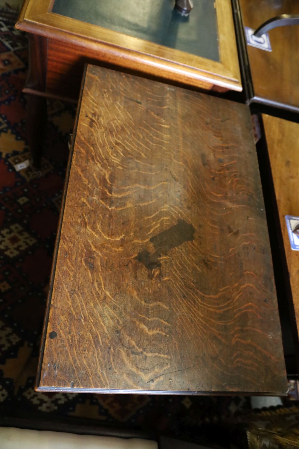 A George III oak low boy, with one long and two short drawers, with brass drop handles, on square section supports, width 79cm, depth 4